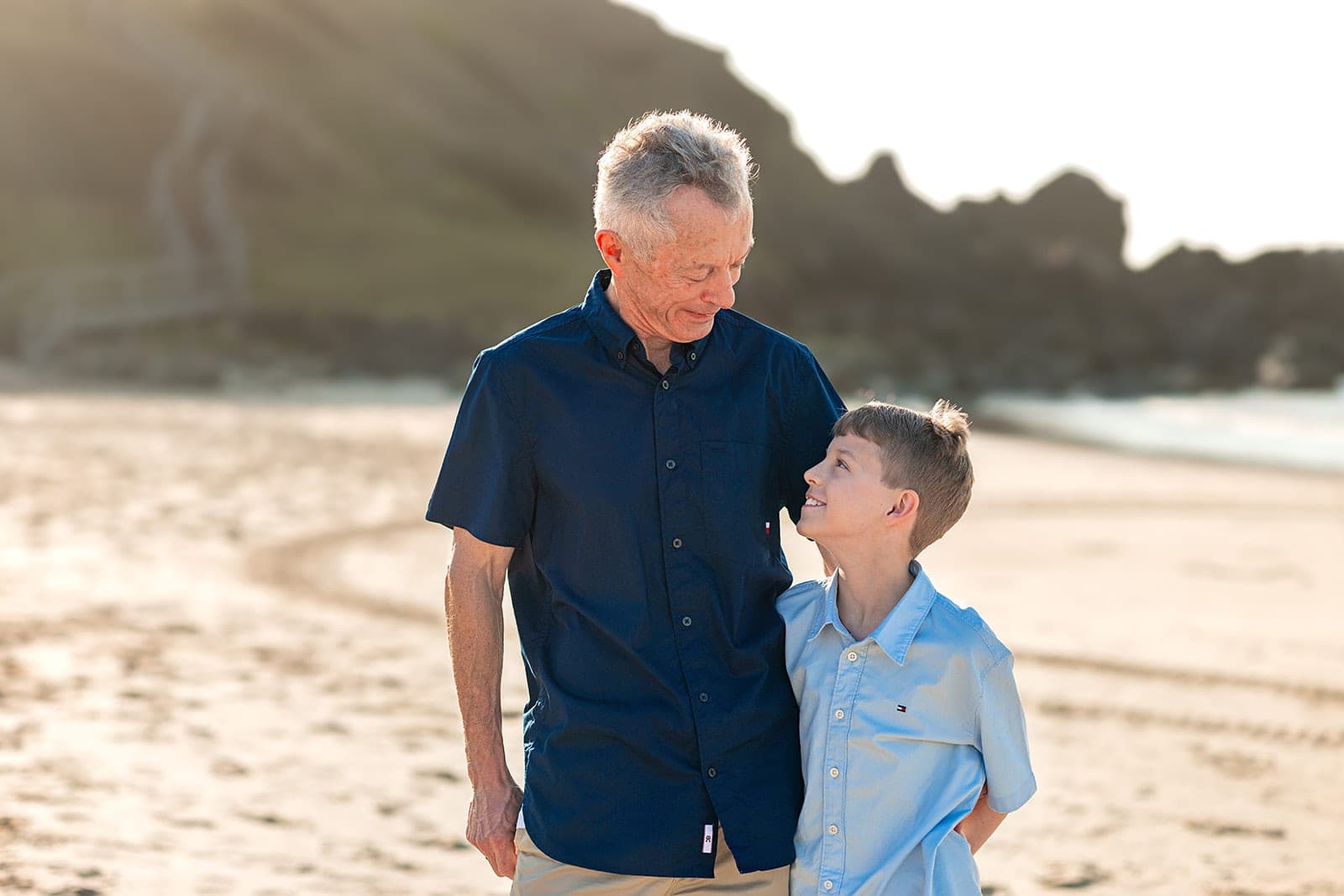 Father and son sharing a laugh on the beach