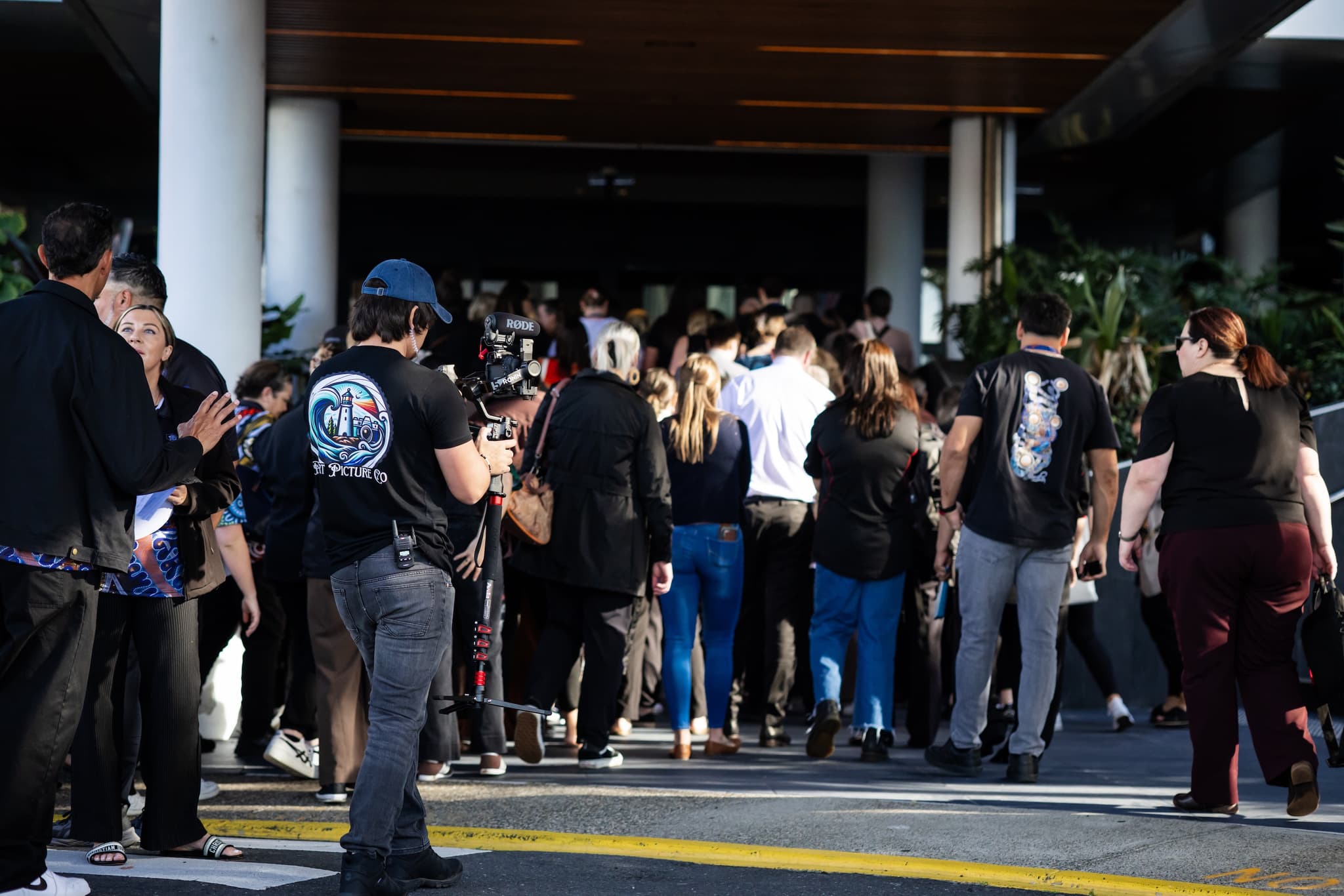 Delegates arriving at the AbSec conference while our videographer films