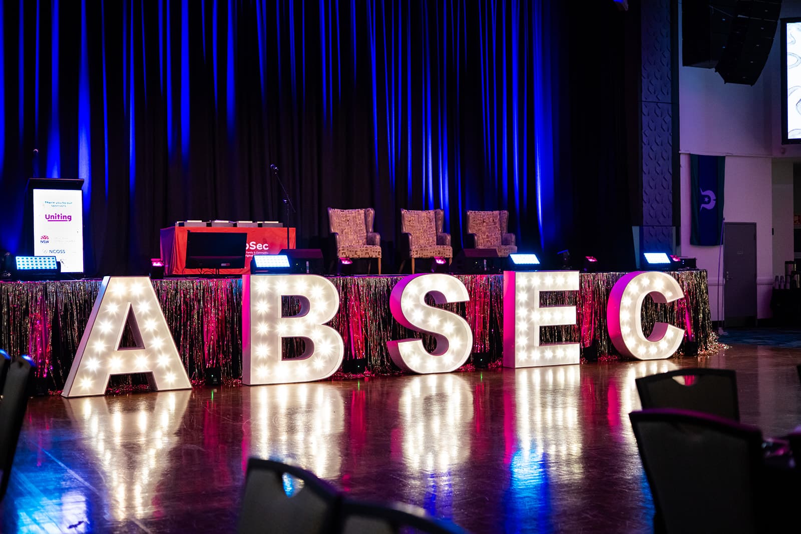 Illuminated ABSEC letters in front of the main stage before the conference opens