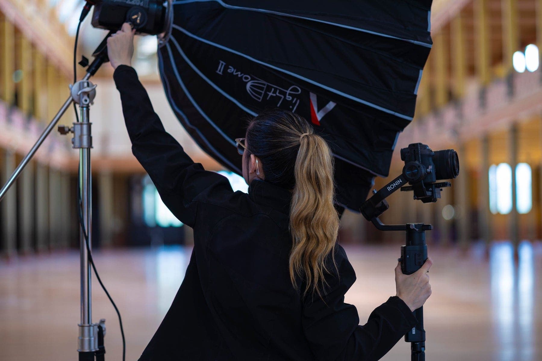 Heather filming with a gimbal and softbox on set