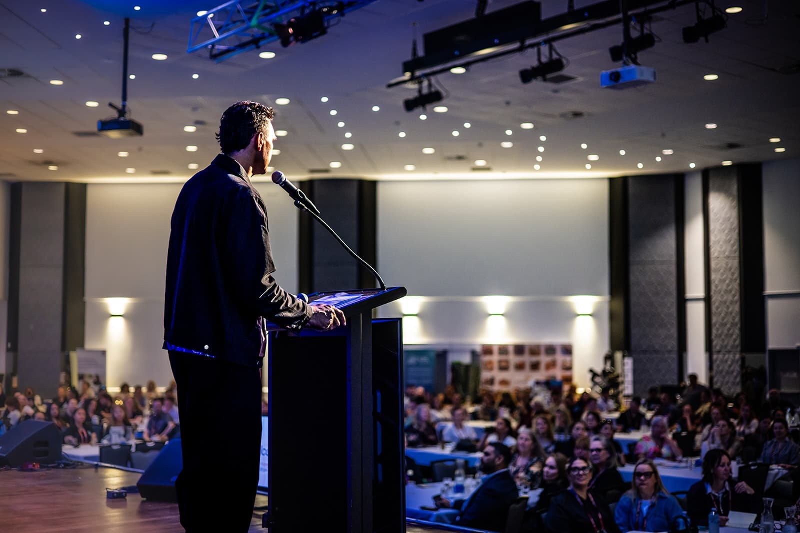 Keynote speaker addressing a full AbSec conference room