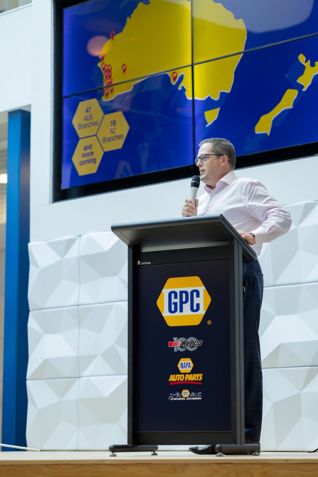 Speaker at a GPC lectern presenting to an audience
