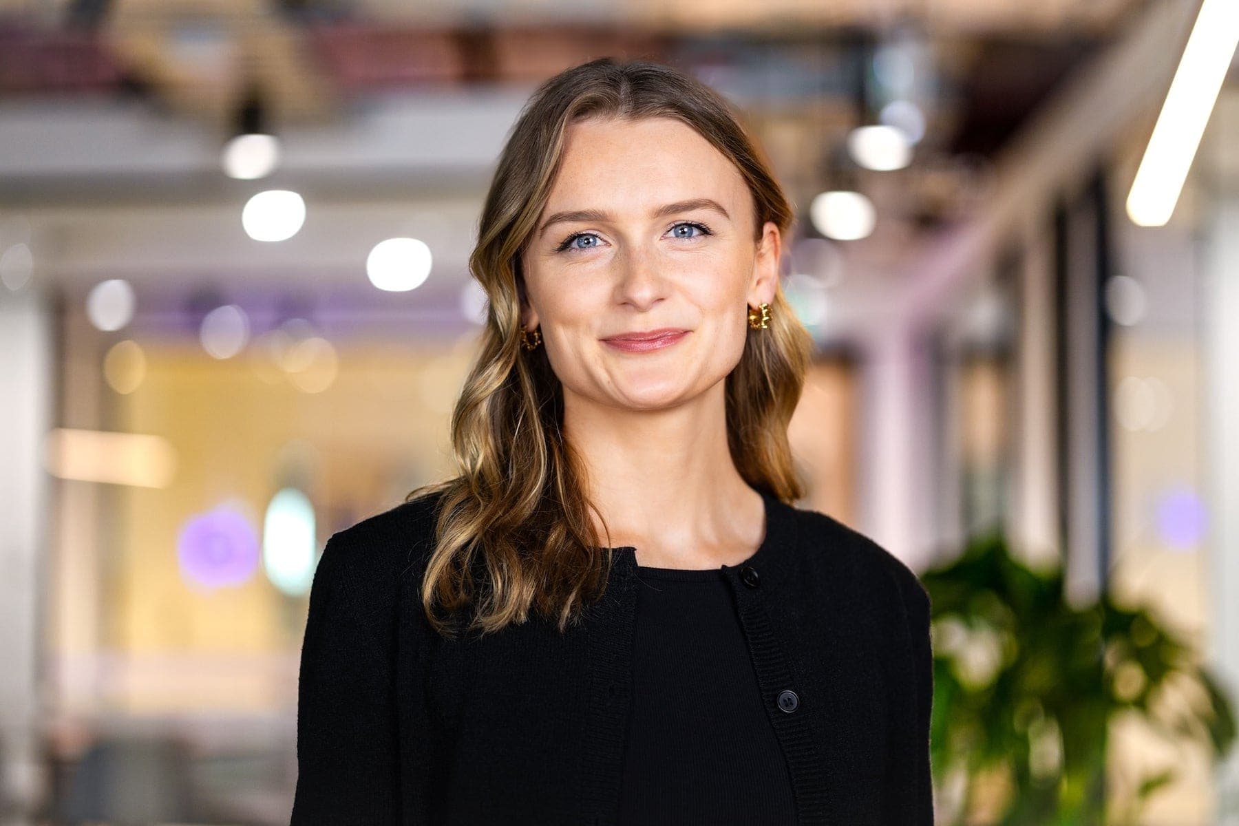 Corporate headshot of a woman in a bright office