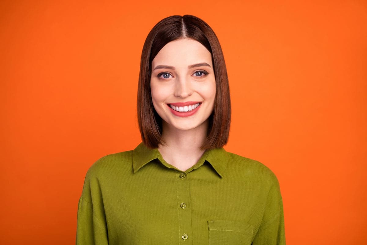 Headshot on a orange studio backdrop