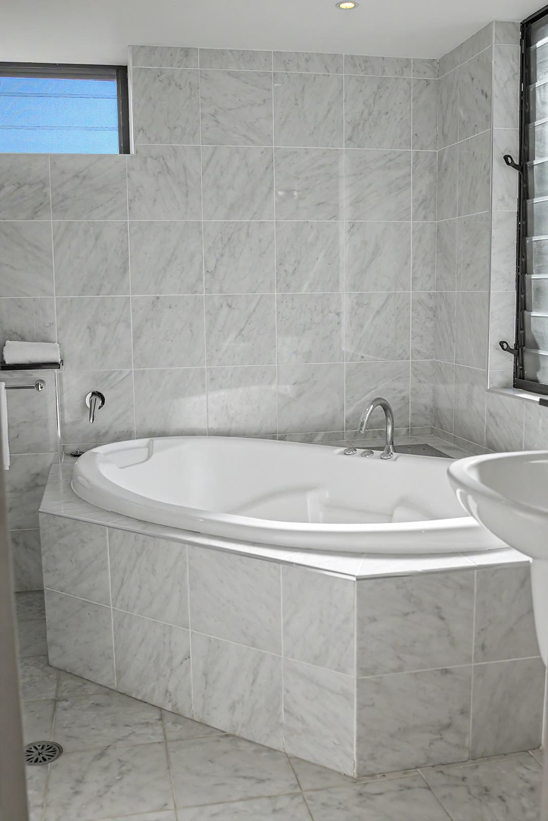 Marble bathroom with a corner spa bath