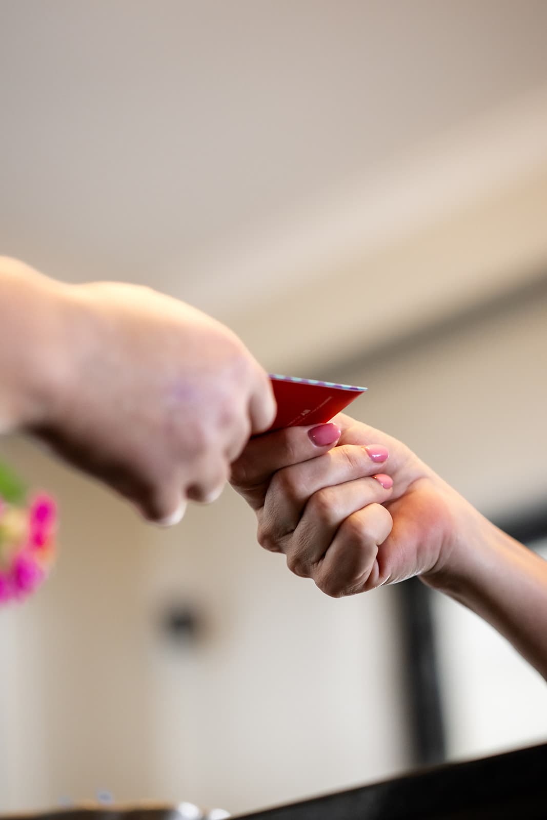 Close-up of a room key card being handed to a guest