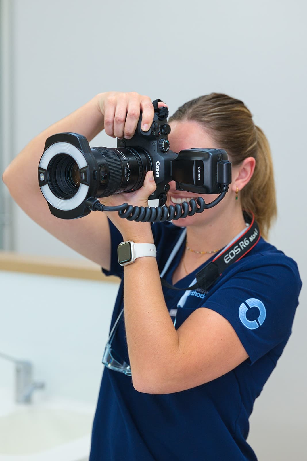 Team member taking clinical photos with a macro ring-flash camera