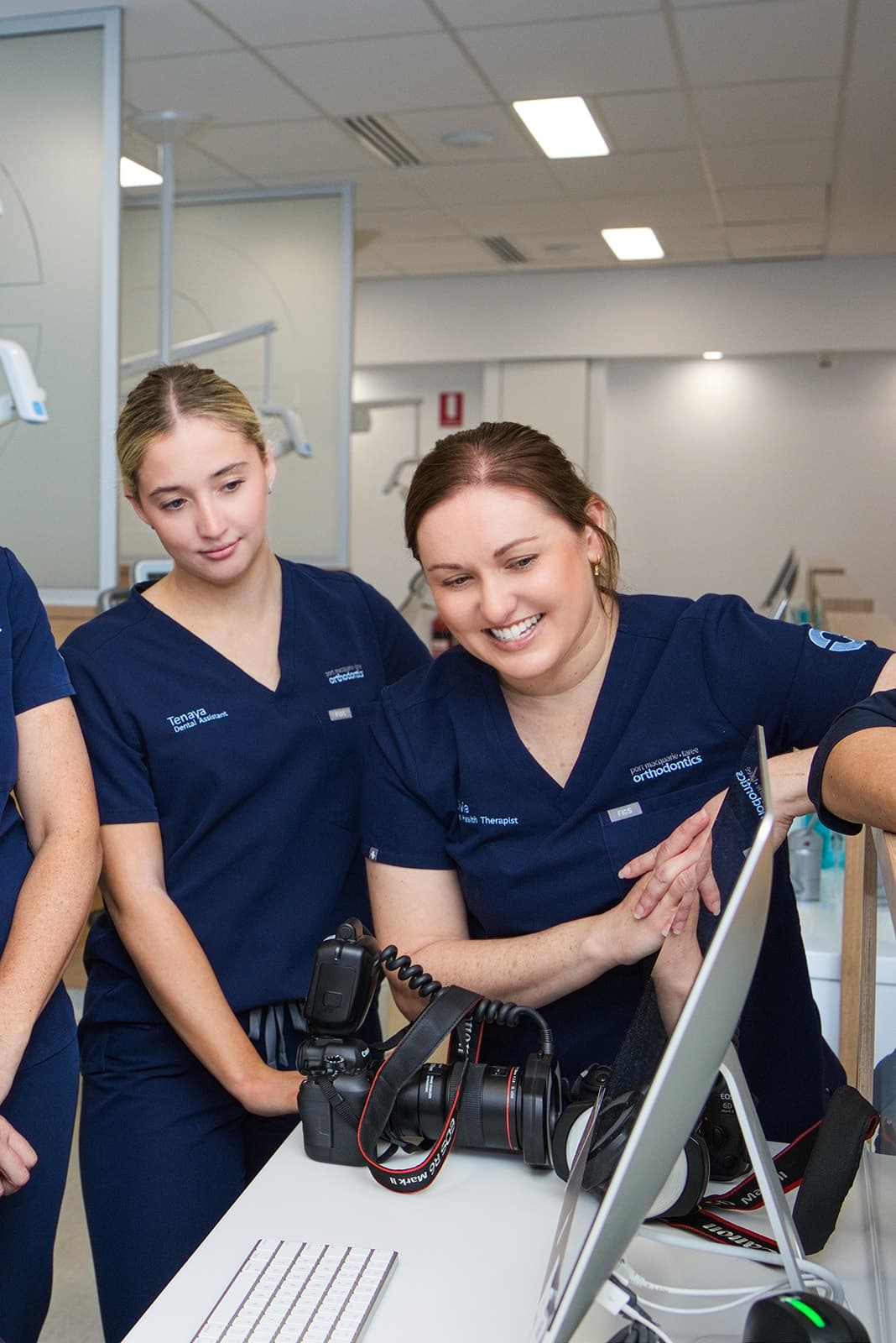 Clinicians reviewing clinical photos on a monitor