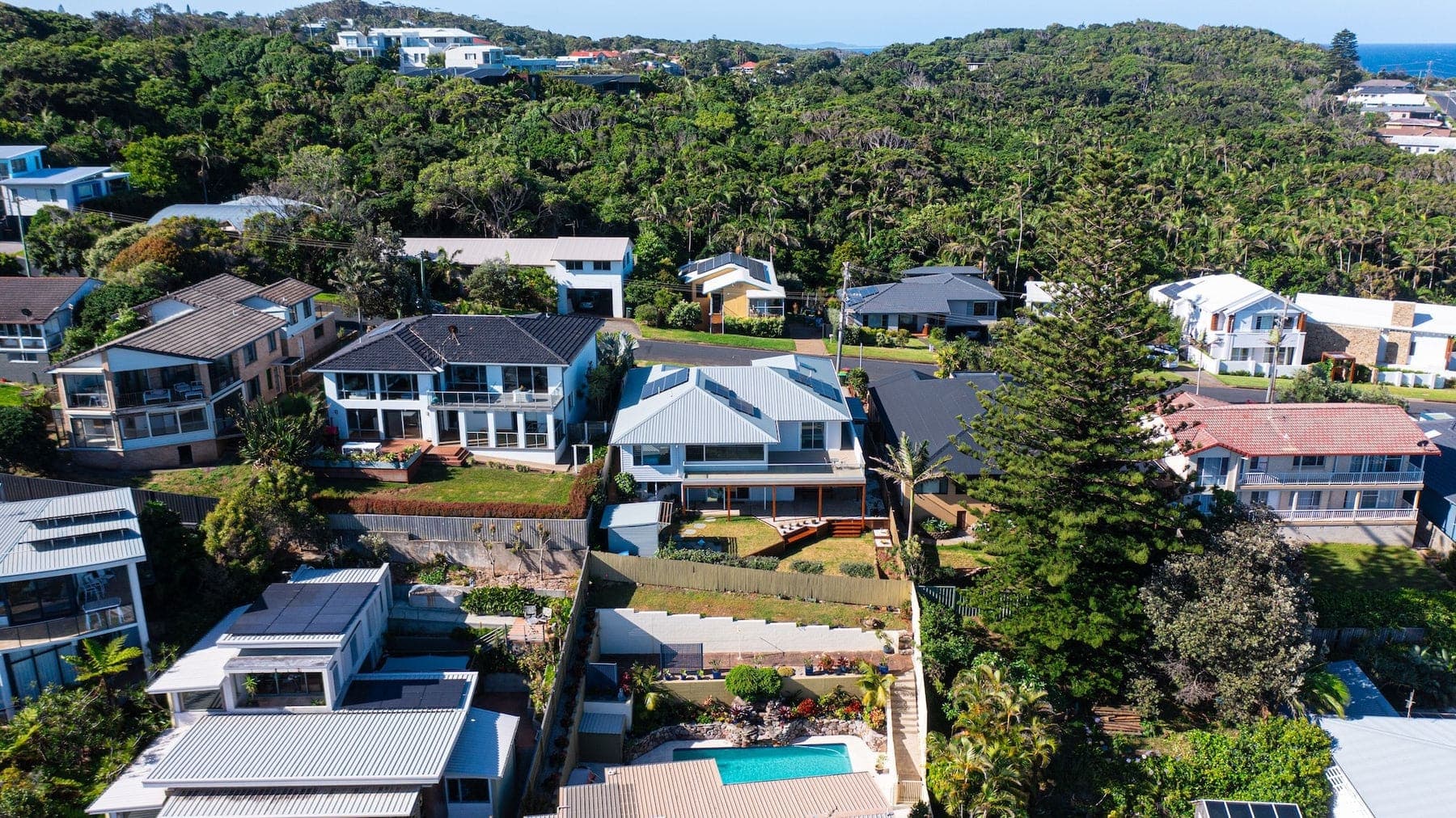Aerial of hillside homes surrounded by bushland