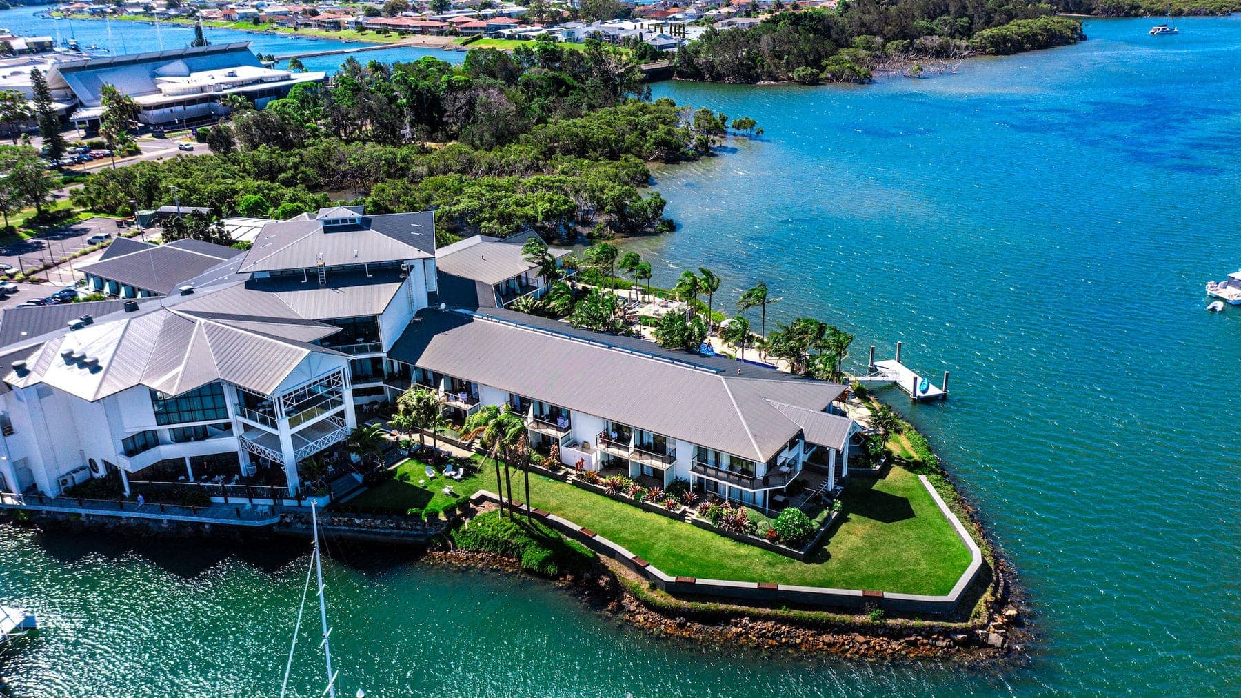 Aerial of a waterfront resort on a green peninsula