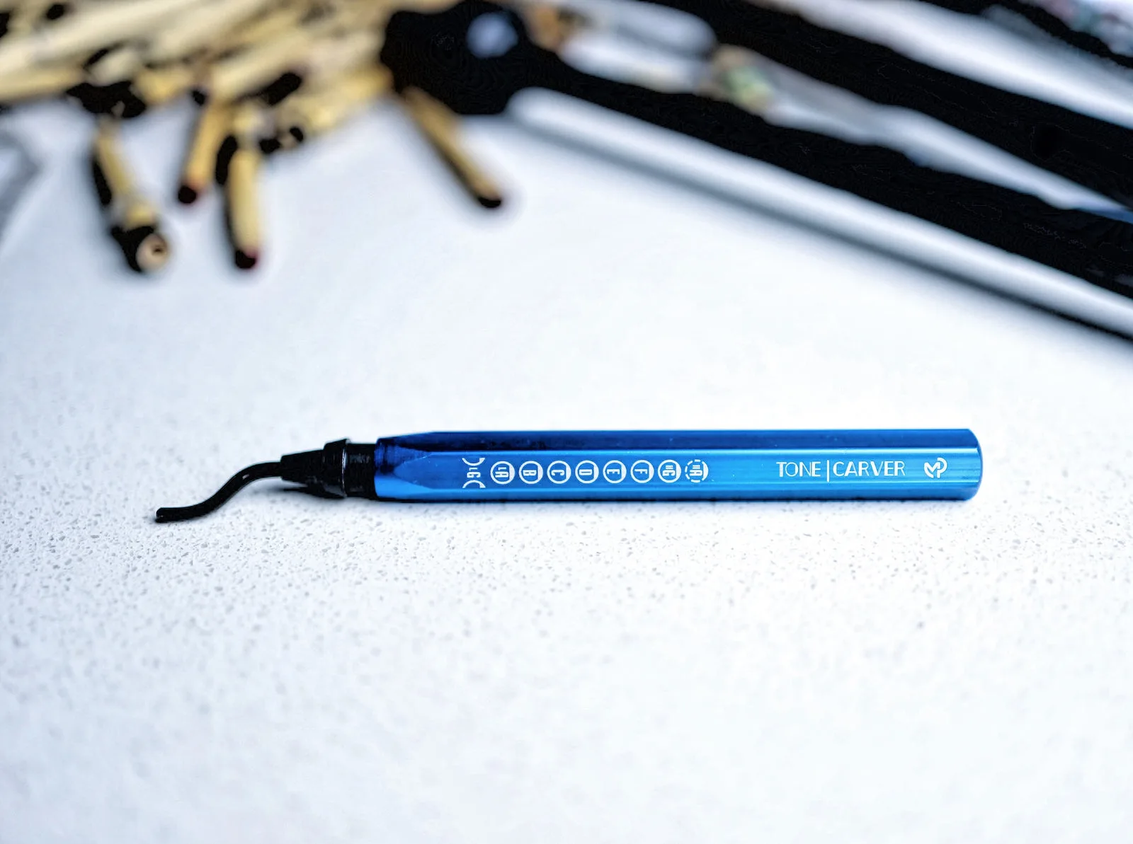 Engraved blue pen lying on a white surface