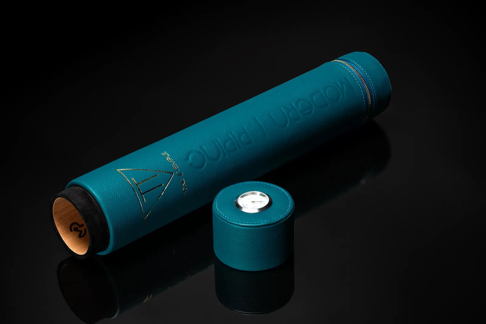 Teal leather case with its cap beside it