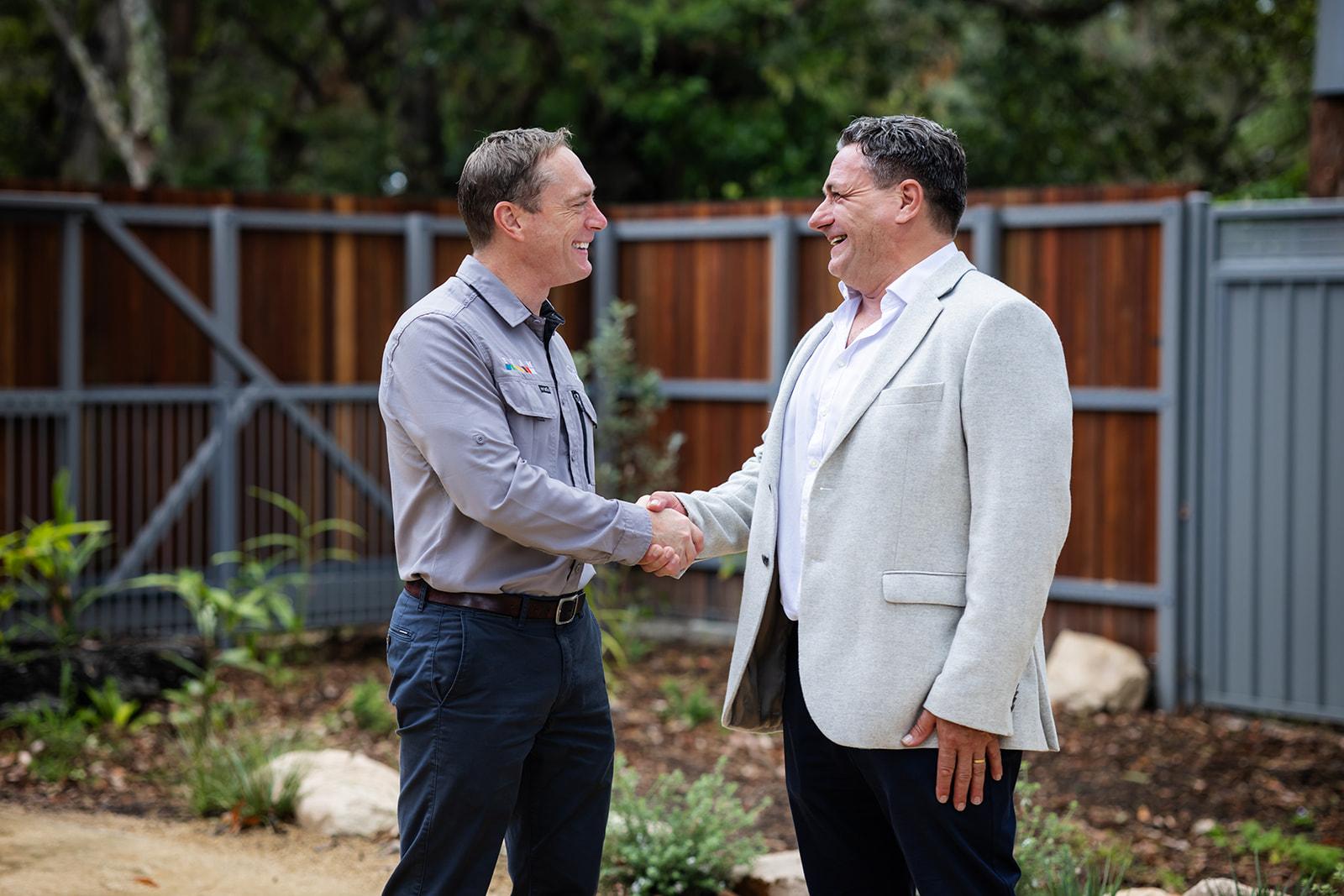 Koala Conservation Australia representative shaking hands with the sponsor representative, both laughing