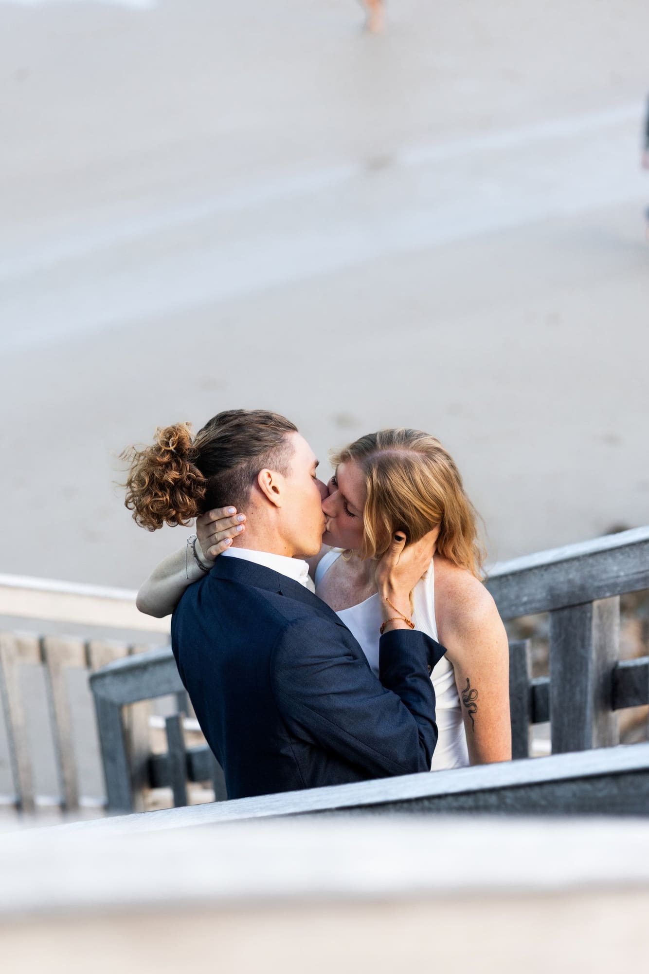 Couple sharing a kiss on cliffside stairs at Port Macquarie